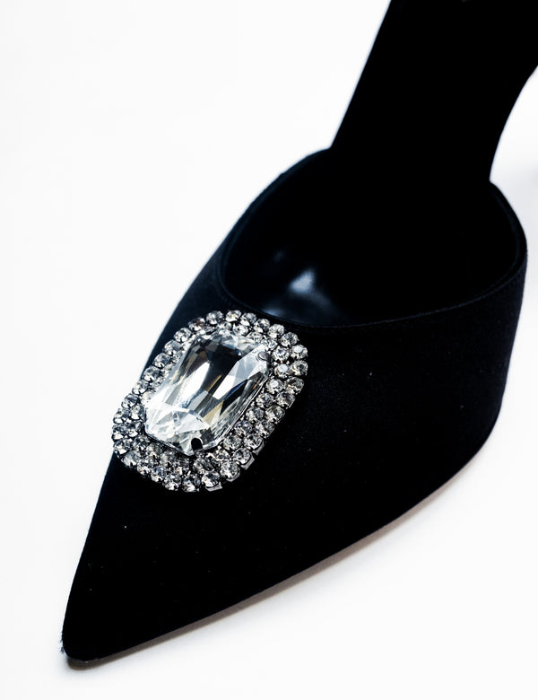 Zena Ziora luxury footwear capsule collection: The Dame pearl stiletto heel with crystal rectangular diamond embellishment in black satin. Zoomed in shot of embellishment at diagonal angle.